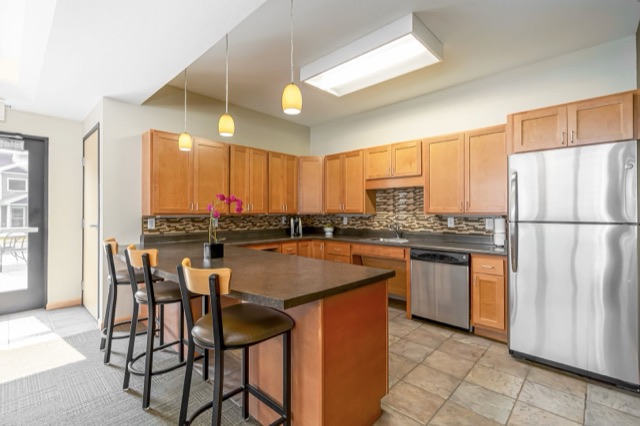 Kitchen with island and stainless appliances at The Aspen